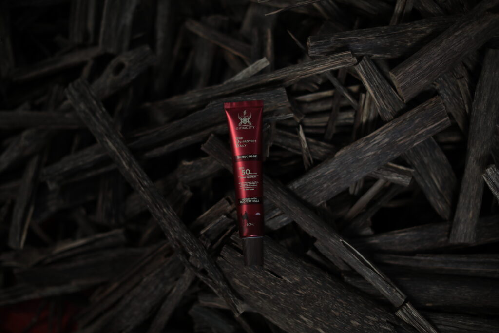 Oudacity® Oud UV-Protect Daily Sunscreen 50ml – world’s first oud-infused SPF 50 sunscreen on natural agarwood background